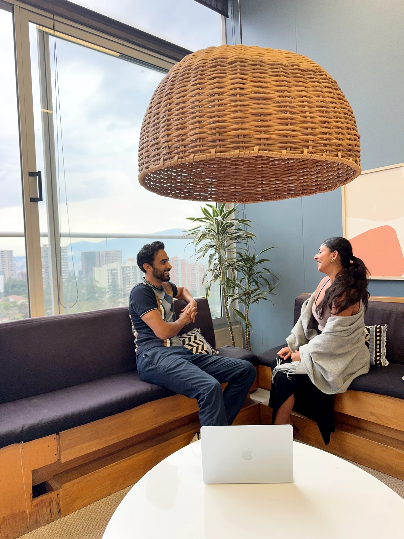 Behroz Saadat and Maha Ali talking together in a shared workspace