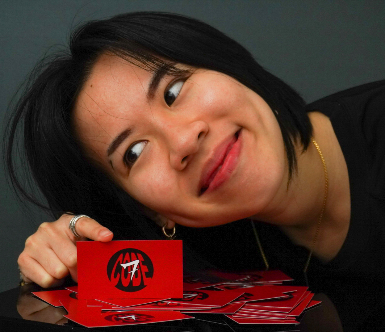 Kyra Tang with red CODE SEVEN brand cards